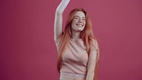 Surprised, happy young redhead, raises her hands and says yes, celebrating Stock Footage 150896147