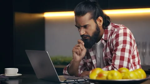 Surprised Indian programmer reading good news email on laptop, career success Stock Footage 316836370