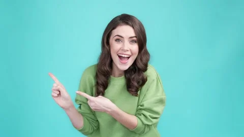 Surprised lady point empty space repost promo isolated cyan color background Stock Footage 169943805