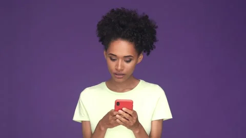 Surprised lady use smart phone share post isolated purple color background Stock Footage 165880124