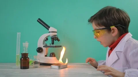 Surprised little boy is making science experiments with fire Stock Footage 104976372