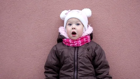 Surprised little girl on the purple background Stock Footage 123211341