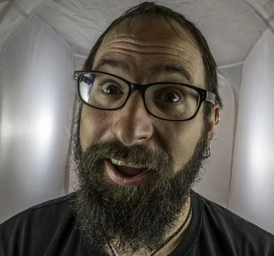 A surprised looking bearded man with glasses Stock Photos