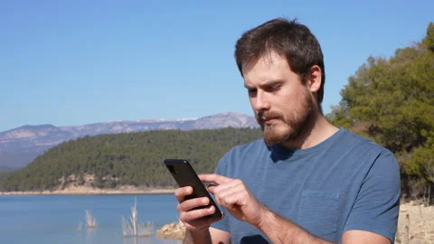 Surprised man cheking phone finding good news outdoor Stock Footage 171941272