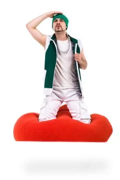 Surprised man dressed like a gnome sitting on red bag with gifts, isolated over Stock Photos