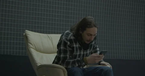 Surprised man gets happy to see crypto pump in smartphone Stock Footage 170701895