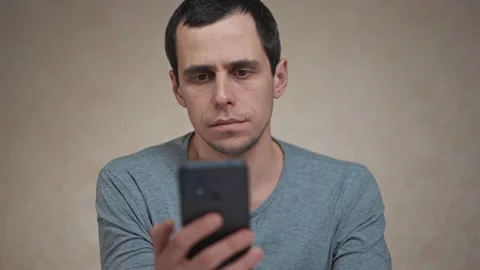 Surprised man looking at mobile phone Stock Footage 170622570