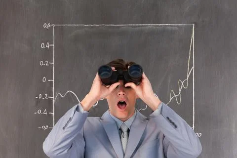Surprised man looking through binoculars against background with infographics 写真素材