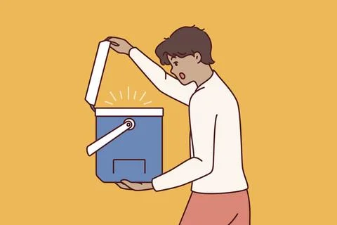 Surprised man opens portable refrigerator for ice cream or drink and is shocked Ilustración de archivo