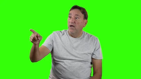 Surprised Man Points on Green Screen Stock Footage 308388214