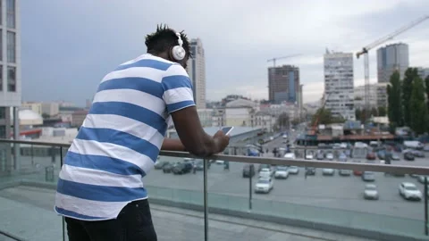 Surprised man reading sms on smart phone outdoors Stock Footage 96077780