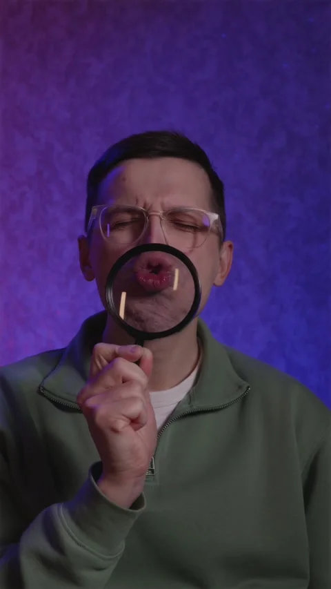 Surprised man shouting Wow several times behind magnifying glass Stock Footage 333757210
