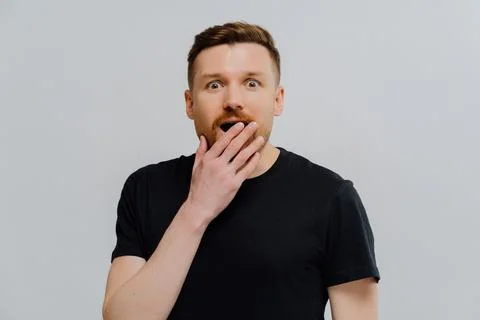 Surprised man staring at camera with opened mouth from excitement Stock Photos