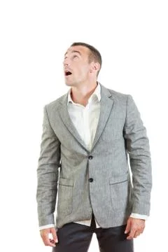 Surprised man in suit posing and looking up Stock Photos