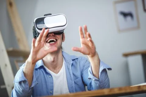Surprised man using VR headset Stock Photos