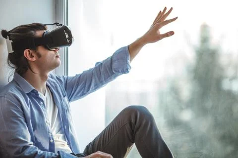 Surprised man using VR headset Stock Photos