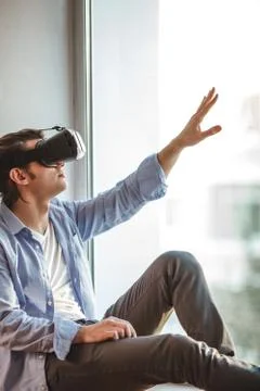 Surprised man using VR headset Stock Photos