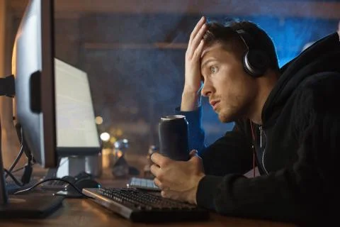 Surprised man working with computer at night Stock Photos