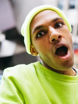 Surprised multiracial man looking at camera in city street Stock Photos