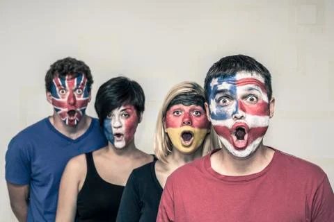Surprised people with flags on faces Stock Photos