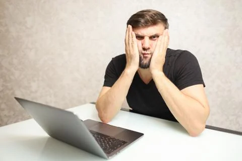 Surprised person working at a computer Foto stock