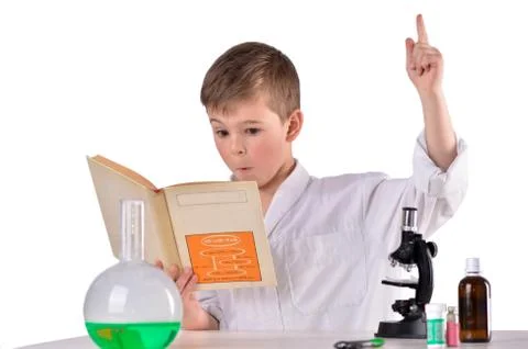 Surprised scientist boy find solution in his book Stock Photos