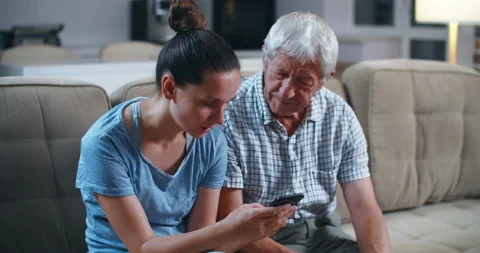 Surprised senior bearded father while sitting on the gray sofa in the light Stock Footage 135979577
