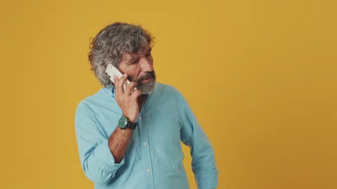 Surprised senior man talking on mobile phone, found out great big win, isolated Stock Footage 252503550
