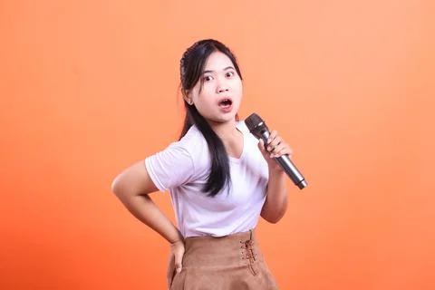 Surprised Singer On Orange Backdrop Stock Photos
