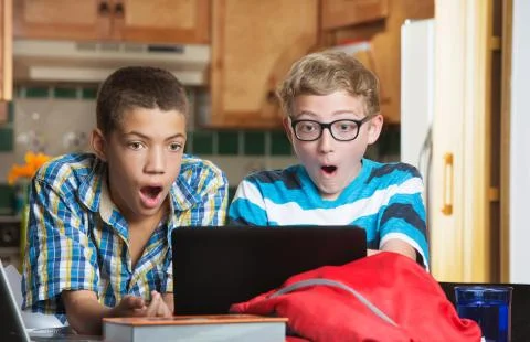 Surprised students looking at computer Stock Photos