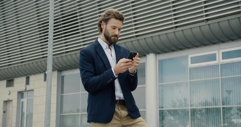 Surprised winner won online looking at his Phone sincerely laughing.  Stock Footage 124017663