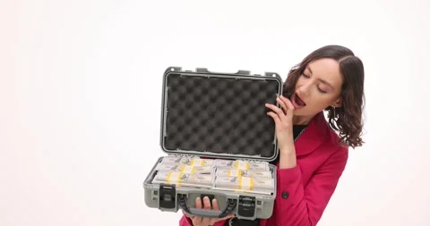 Surprised woman in blazer opens briefcase with stacks of money Stock Footage 313286453