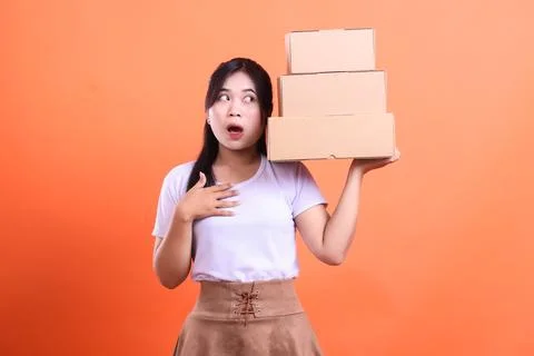 Surprised woman carrying stack of boxes. Stock Photos