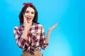 The surprised woman gesturing on the blue background Photo