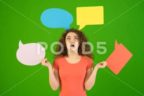 The surprised woman hold a dialog signs on the green background Stock Photos
