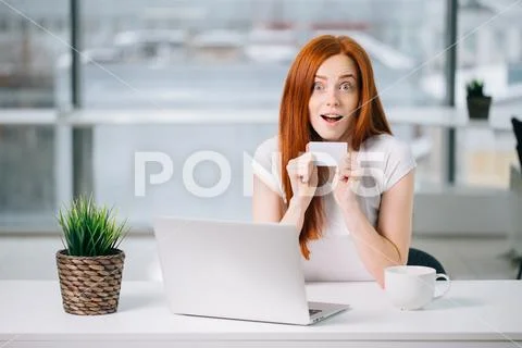 Surprised woman holding credit card, and make online payment by plastic card Stock Photos