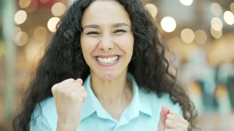 Surprised woman looking at camera while standing indoors. He looks at the shop  Stock Footage 221047698