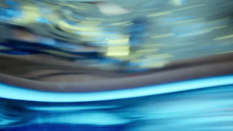 Surprised Woman Looking at Reflection in Distorting Mirror in Multicolored Light Stock Footage 306981071