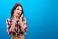 The surprised woman standing on the blue background Photo