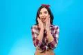 The surprised woman standing on the blue background Photo