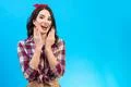 The surprised woman standing on the blue background Photo