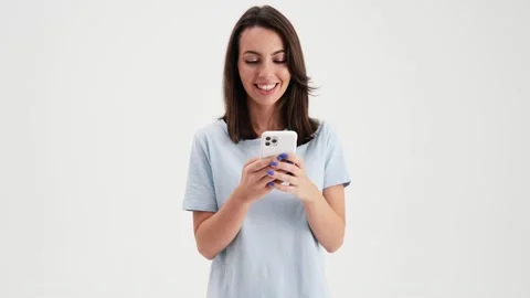 A surprised woman wearing basic t-shirt doing winner gesture Stock Footage 157867226