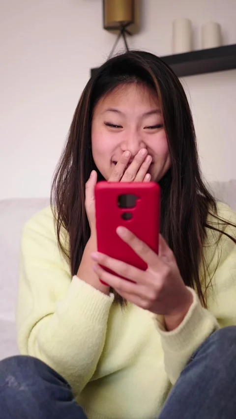 Surprised young Asian student checking pass lists on mobile phone. Excited Stock Footage 275165795