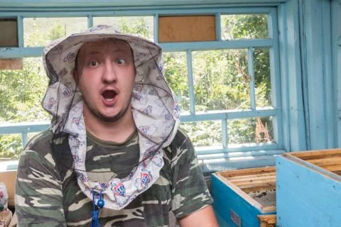 Surprised young beekeeper on an apiary. Stock Photos