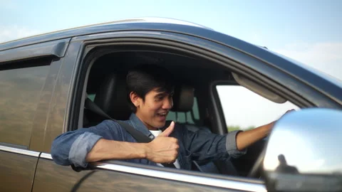 Surprised young handsome man thumbs up in getting the new car. He hugged. Stock Footage 233234323