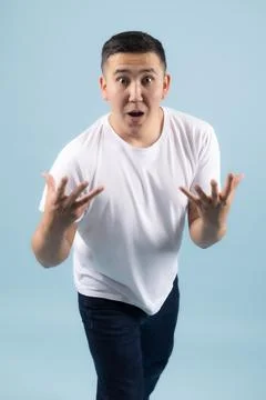 Surprised Young Man Gesturing with Open Hands 스톡 사진