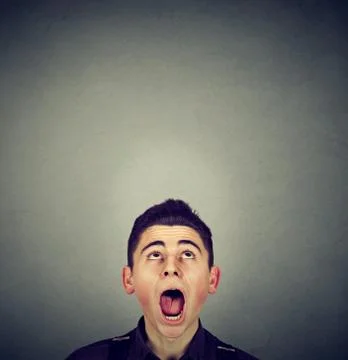 Surprised young man looking up Stock Photos