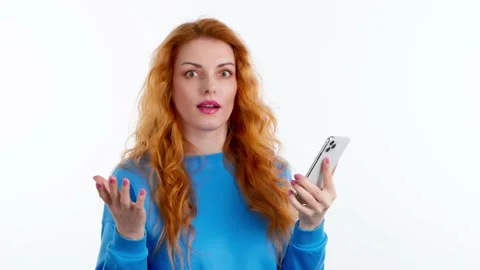 Surprised young woman pointing at mobile Stock Footage 236420437