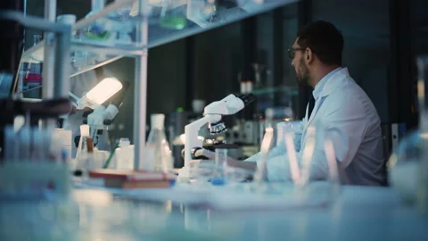 Surprized Scientist Makes Discovery Under Microscope Video stock 142226756