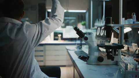 Surprized Scientist Makes Discovery Under Microscope Video stock 142226831